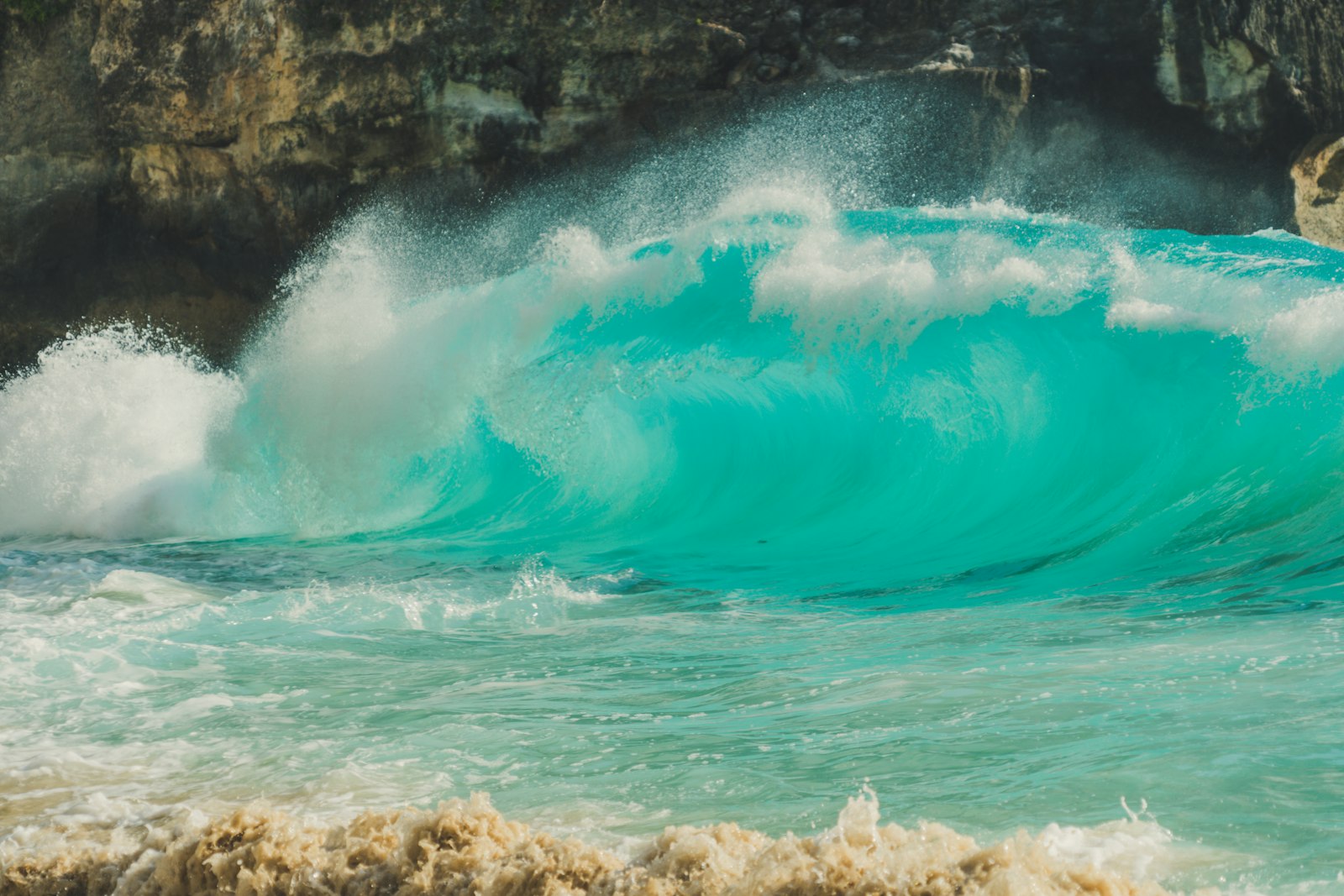 Turquoise wave breaking near Kelingking, Nusa Penida