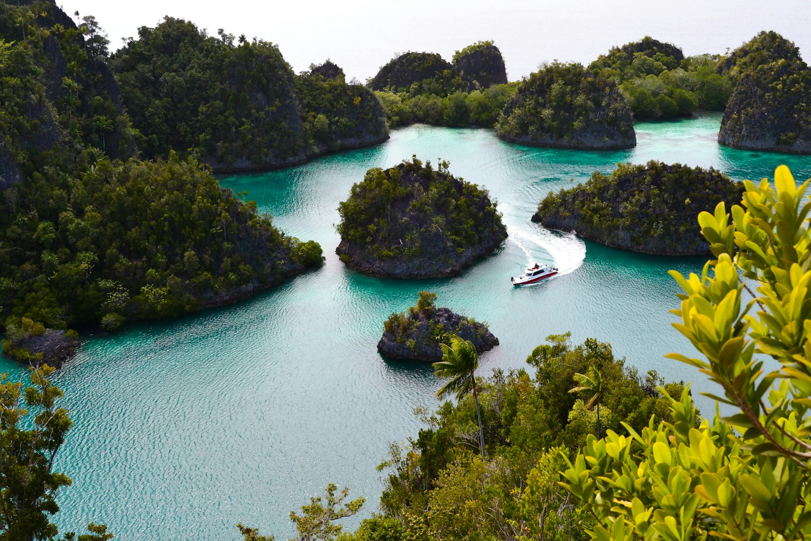 Boat winding through the karst lagoon, Raja Ampat